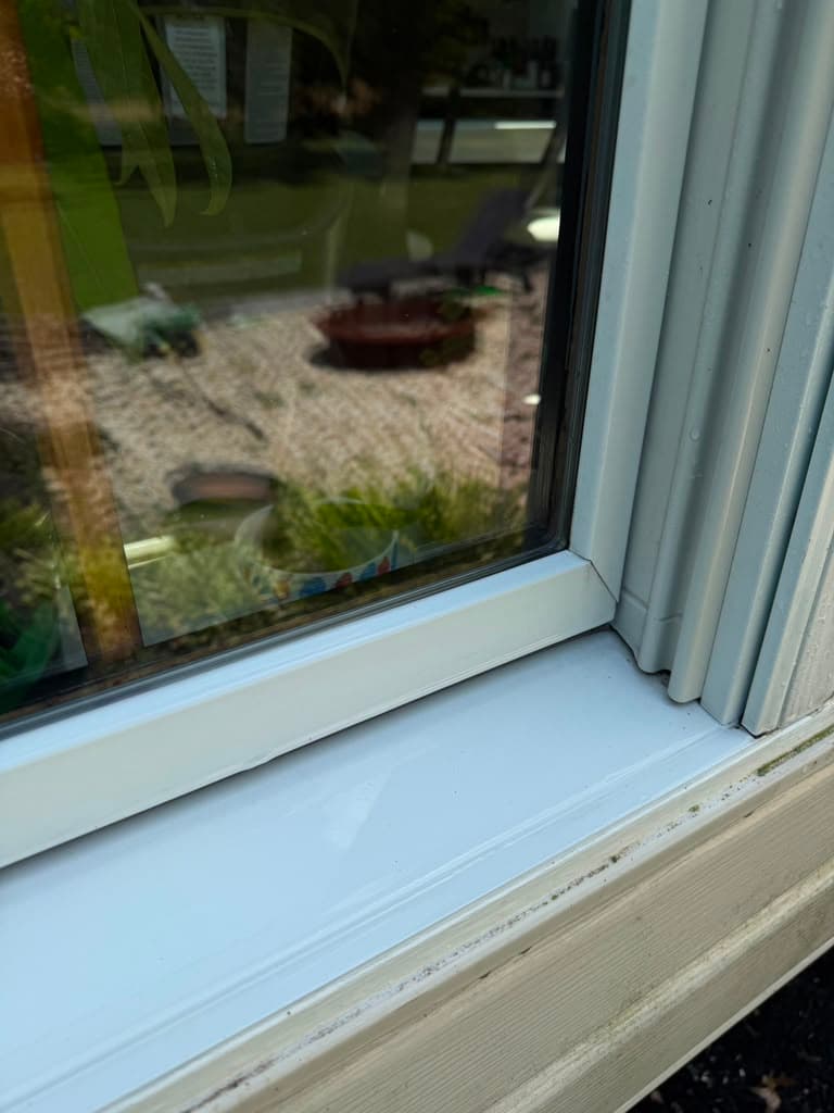 The same window sill cleaned back to white after exterior window cleaning