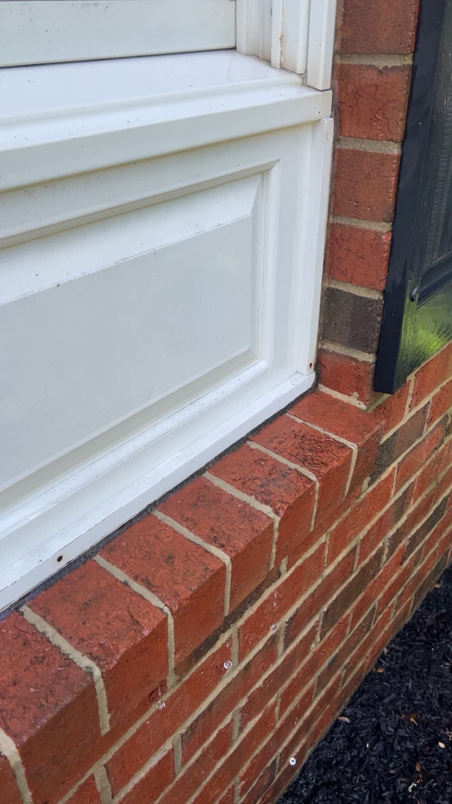 The same brick window sill cleaned back to bare brick